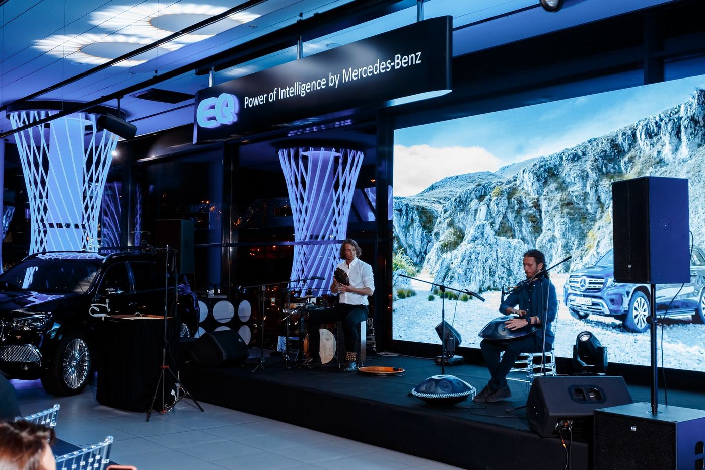 The Mercedes-EQ stage: frame drum and live sand animation on screen