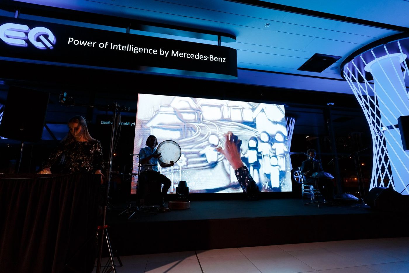 The Mercedes-EQ stage: frame drum and live sand animation on screen