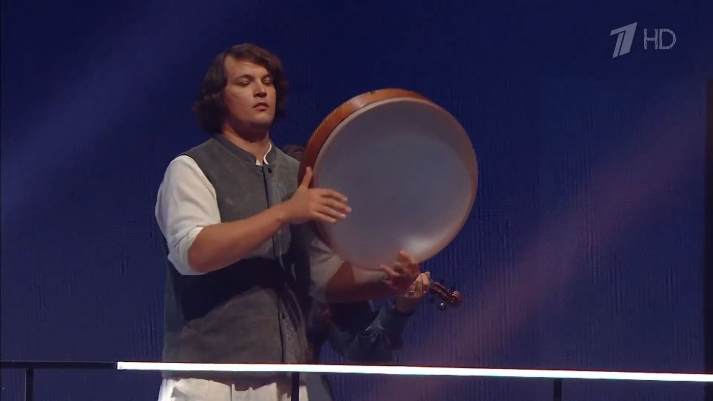 Erik Markovsky with a frame drum on the main stage of the International Youth Festival